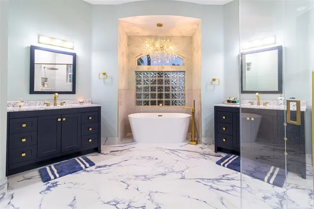 a bathroom with a bathtub sink and mirror
