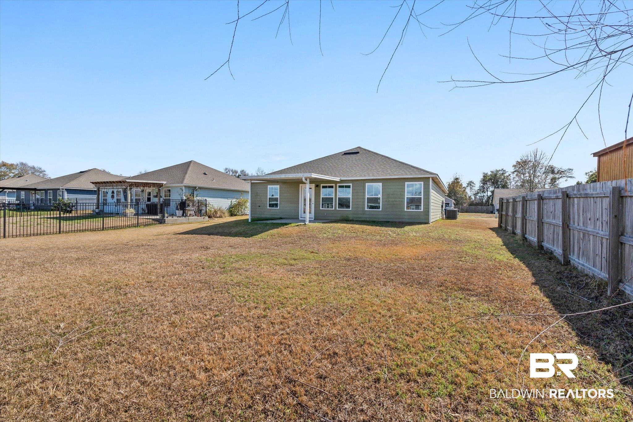 919 Sailor Circle Foley, AL 36535 - Photo 21 of 24 Rear view of house featuring a fenced backyard and a patio area