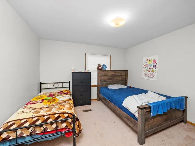 a bedroom with furniture and a dresser