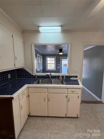 a large white kitchen with a large window