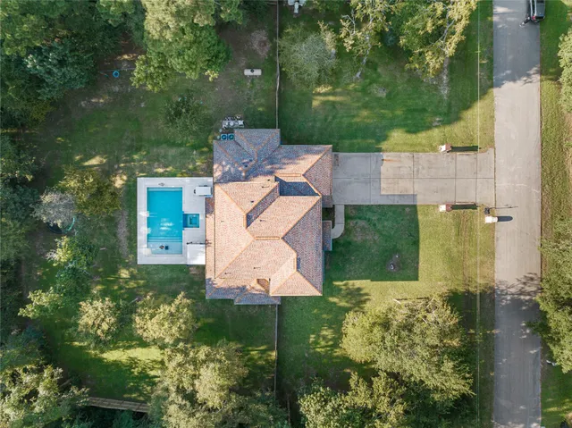 an aerial view of a house with a yard and garden