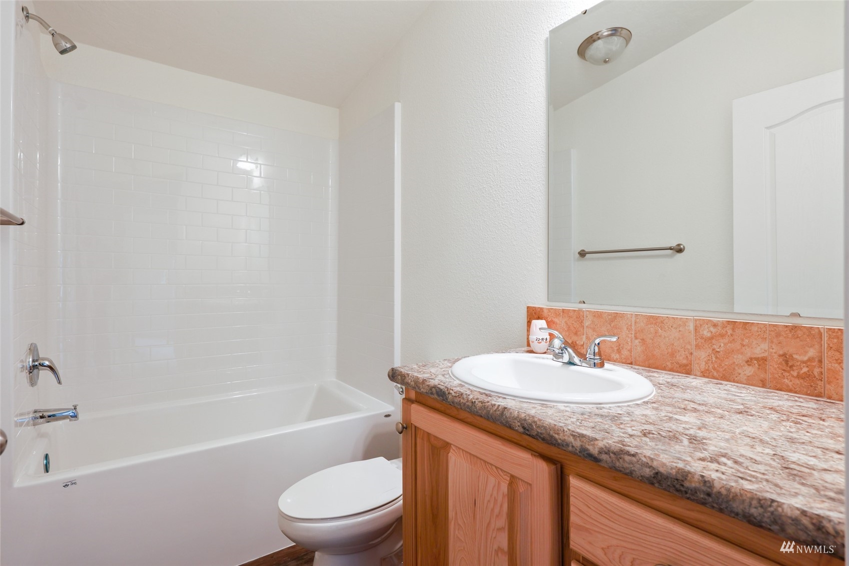 18737 Hilt Street Southwest Rochester, WA 98579 - Photo 15 of 29 a bathroom with a granite countertop sink a toilet and bathtub