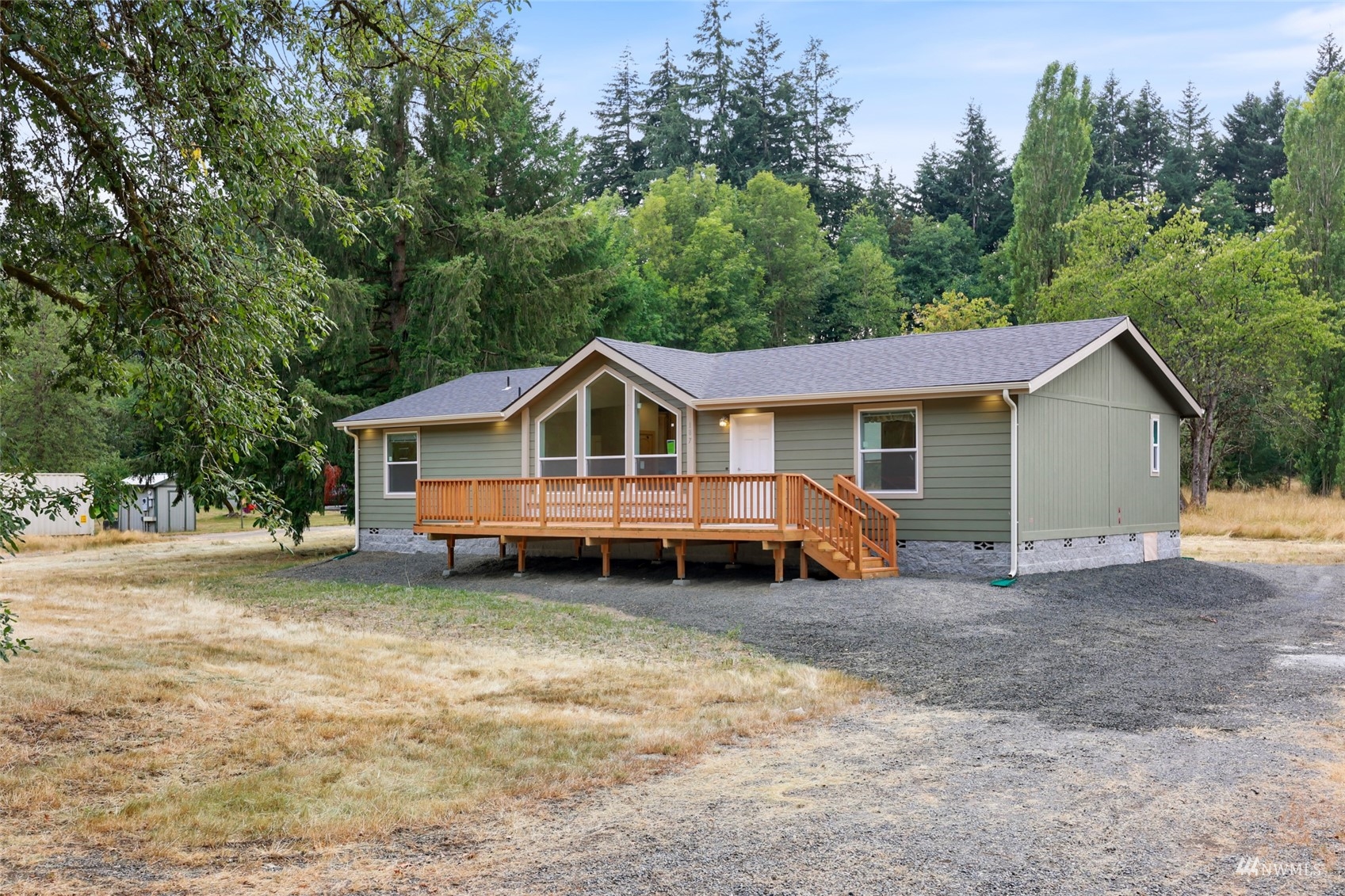 18737 Hilt Street Southwest Rochester, WA 98579 - Photo 21 of 29 a view of house with a yard and large trees