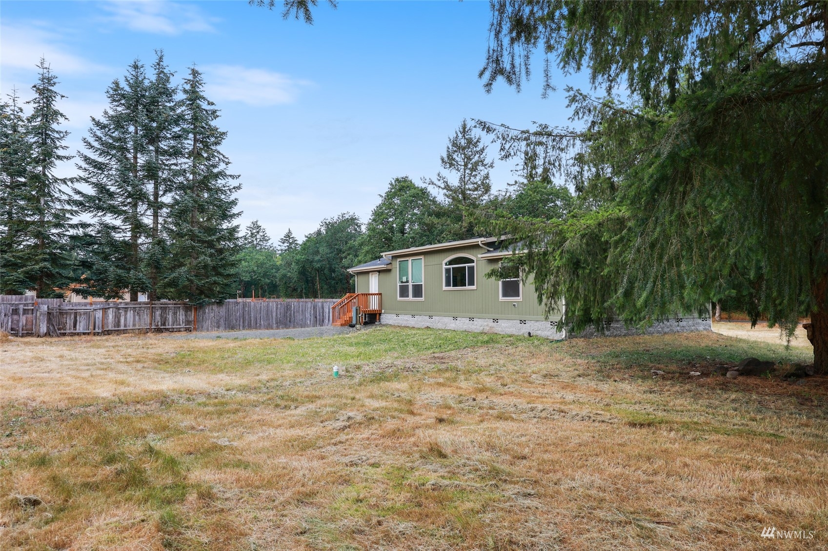 18737 Hilt Street Southwest Rochester, WA 98579 - Photo 26 of 29 a backyard of a house with lots of green space