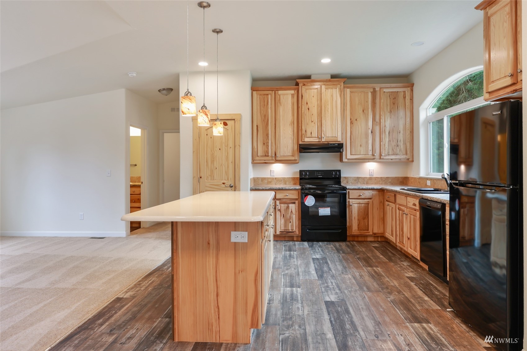 18737 Hilt Street Southwest Rochester, WA 98579 - Photo 4 of 29 a kitchen with a refrigerator a sink dishwasher and a stove with wooden floor