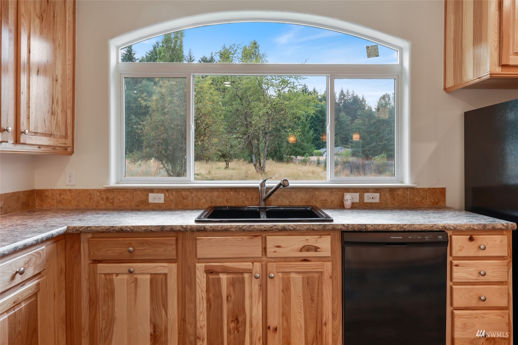 18737 Hilt Street Southwest Rochester, WA 98579 - Photo 7 of 29 a kitchen with granite countertop a sink and a window