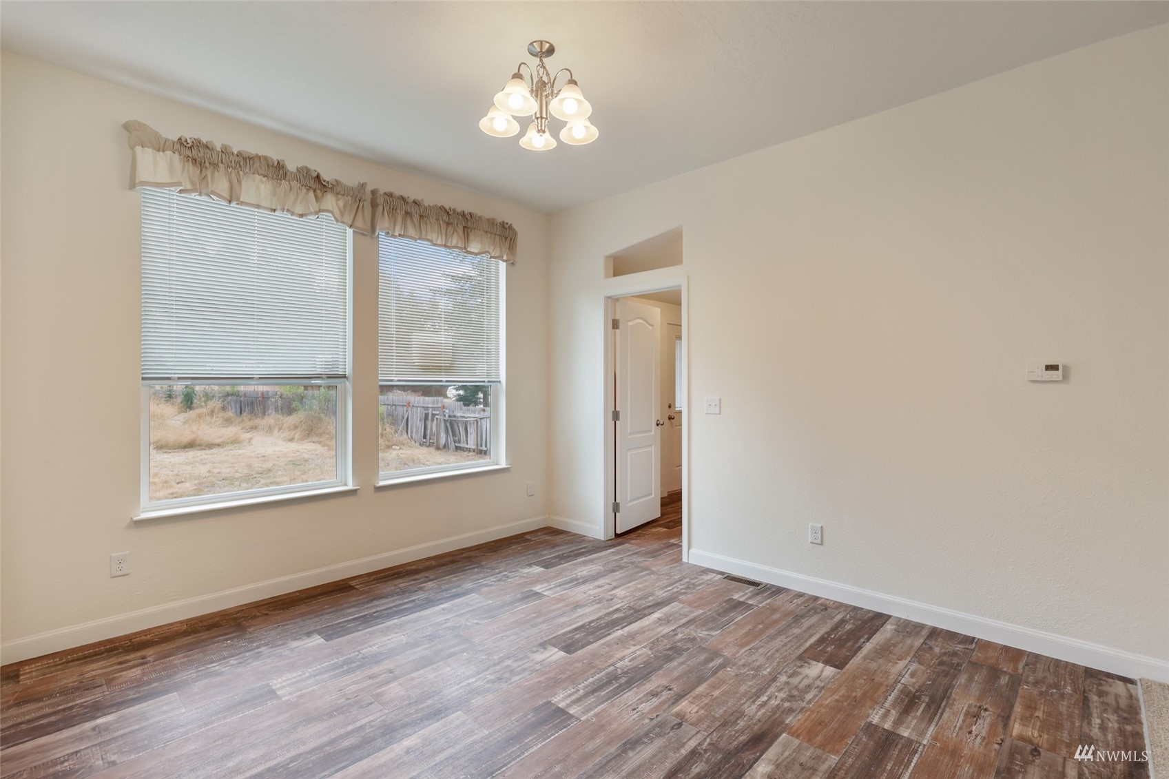 18737 Hilt Street Southwest Rochester, WA 98579 - Photo 9 of 29 a view of an empty room with a window and hardwood floor
