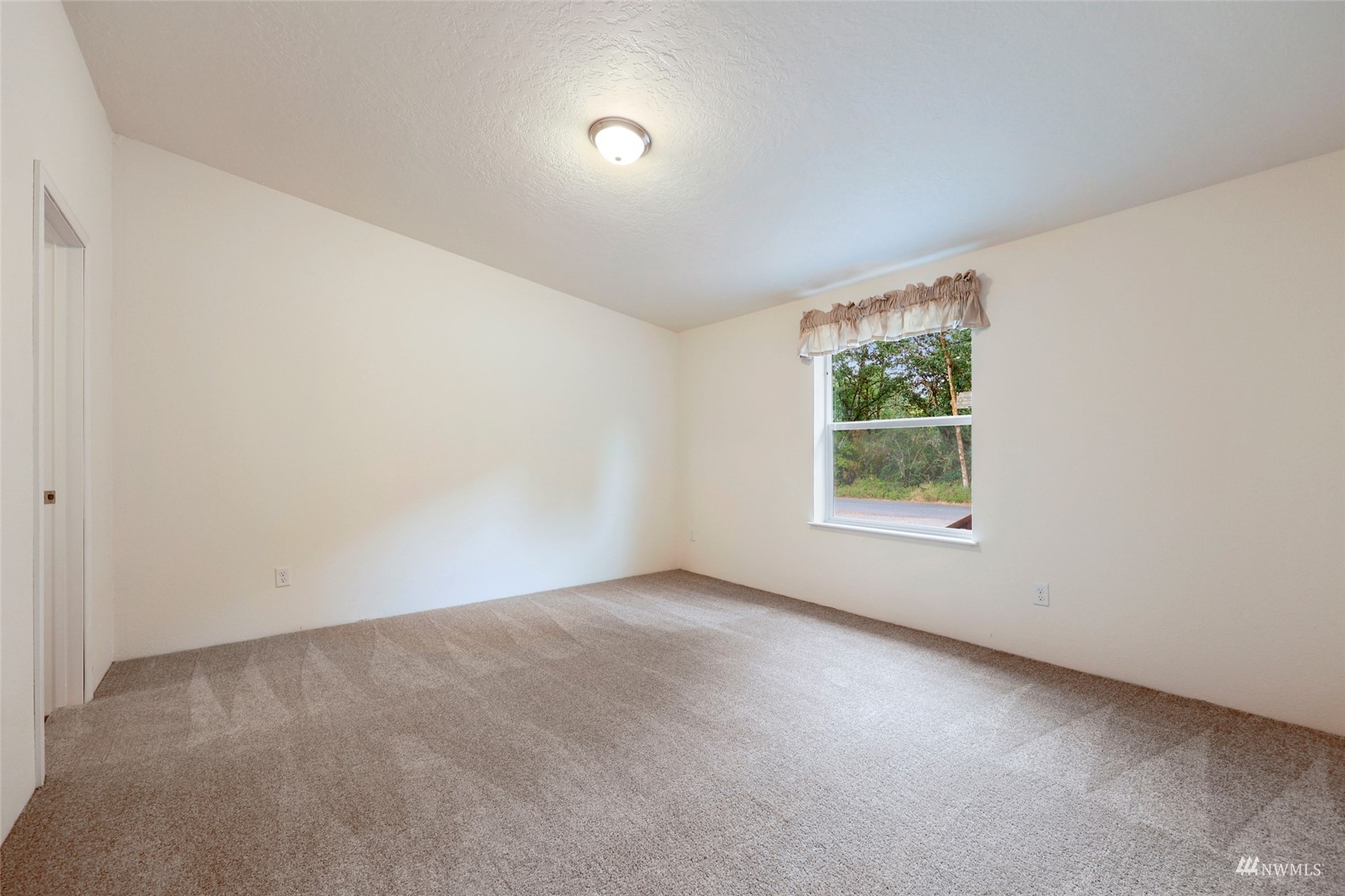 18737 Hilt Street Southwest Rochester, WA 98579 - Photo 10 of 29 an empty room with windows