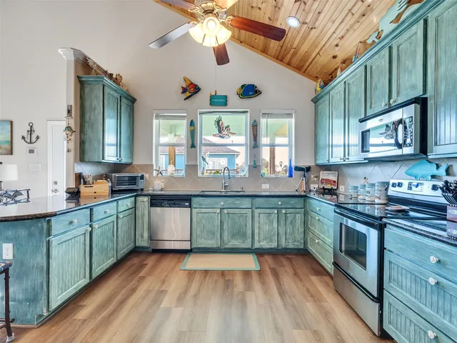 a bathroom with a granite countertop sink and a toilet