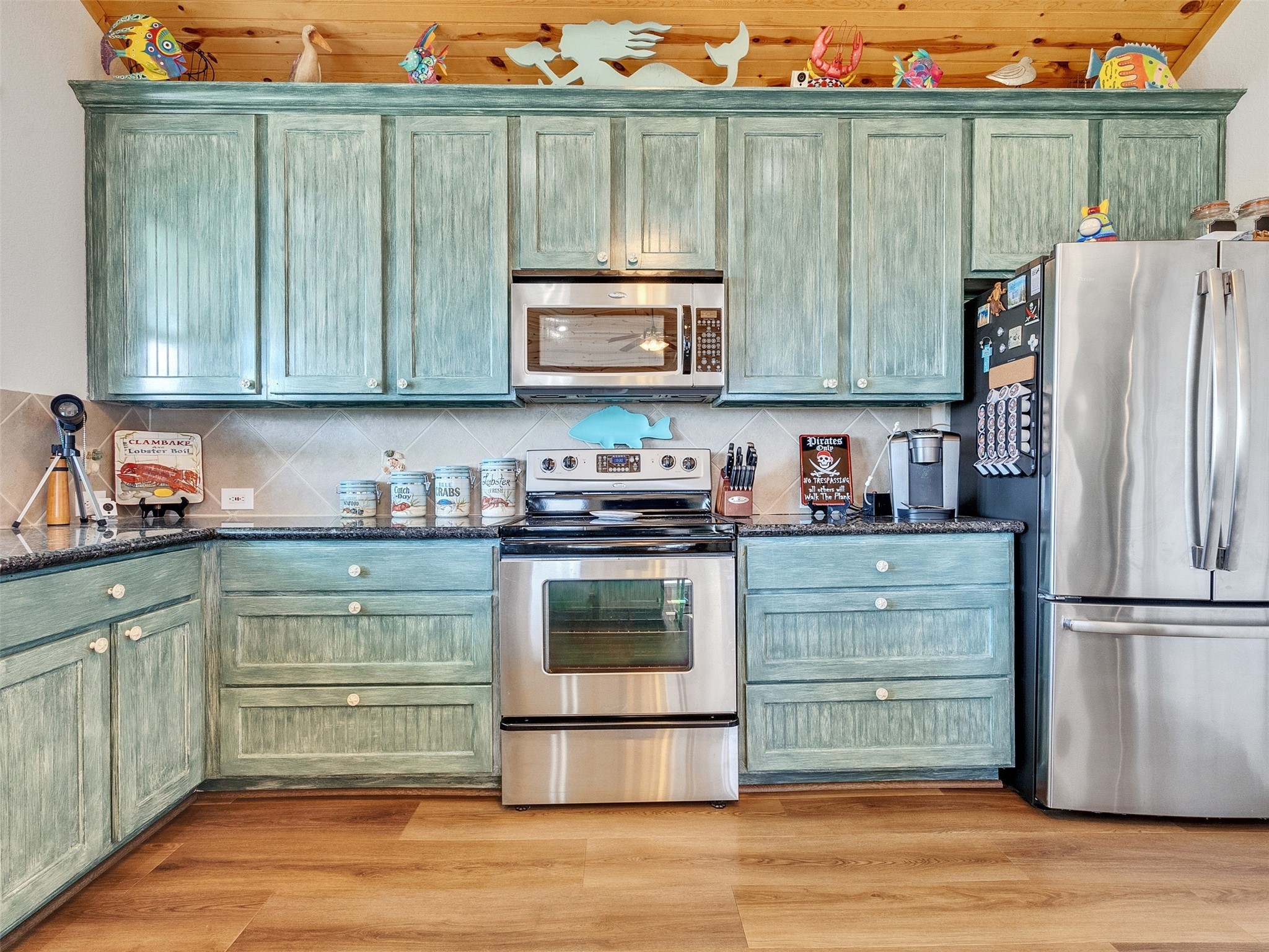 4710 Palm Street Freeport, TX 77541 - Photo 16 of 23 a kitchen with granite countertop a refrigerator and a stove top oven