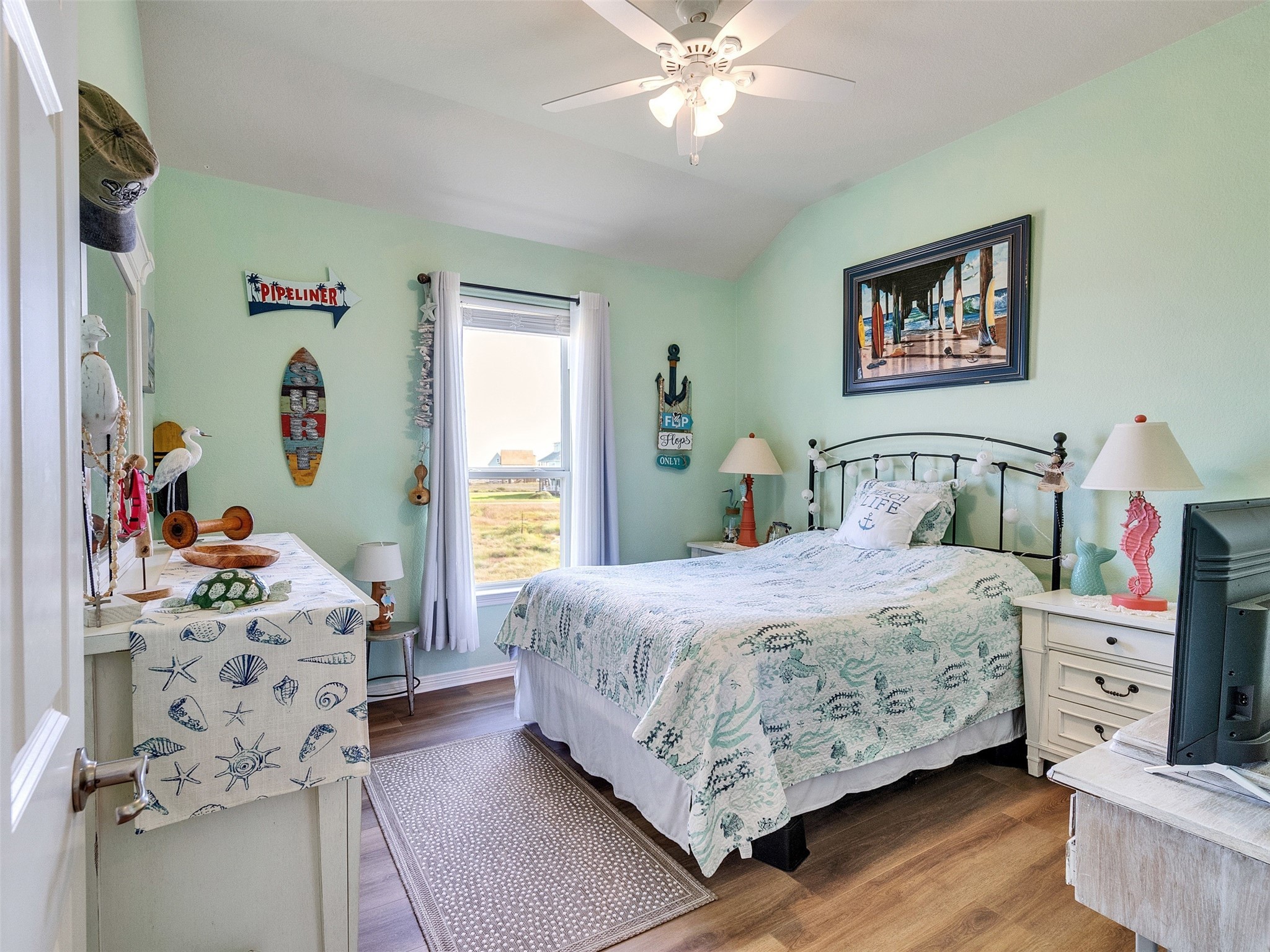 4710 Palm Street Freeport, TX 77541 - Photo 22 of 23 a bedroom with a bed and a chandelier