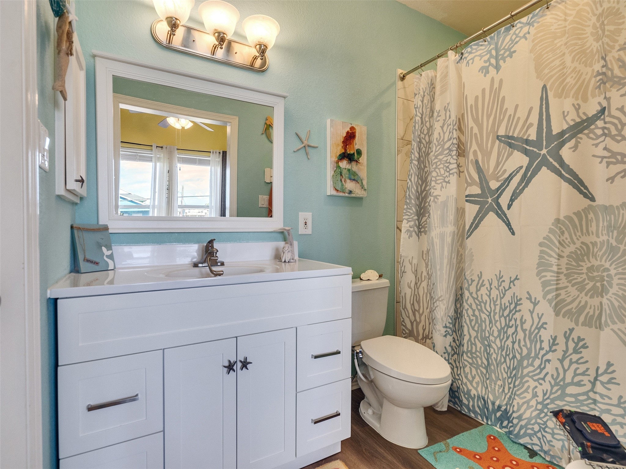 4710 Palm Street Freeport, TX 77541 - Photo 23 of 23 a bathroom with a granite countertop sink mirror vanity and toilet