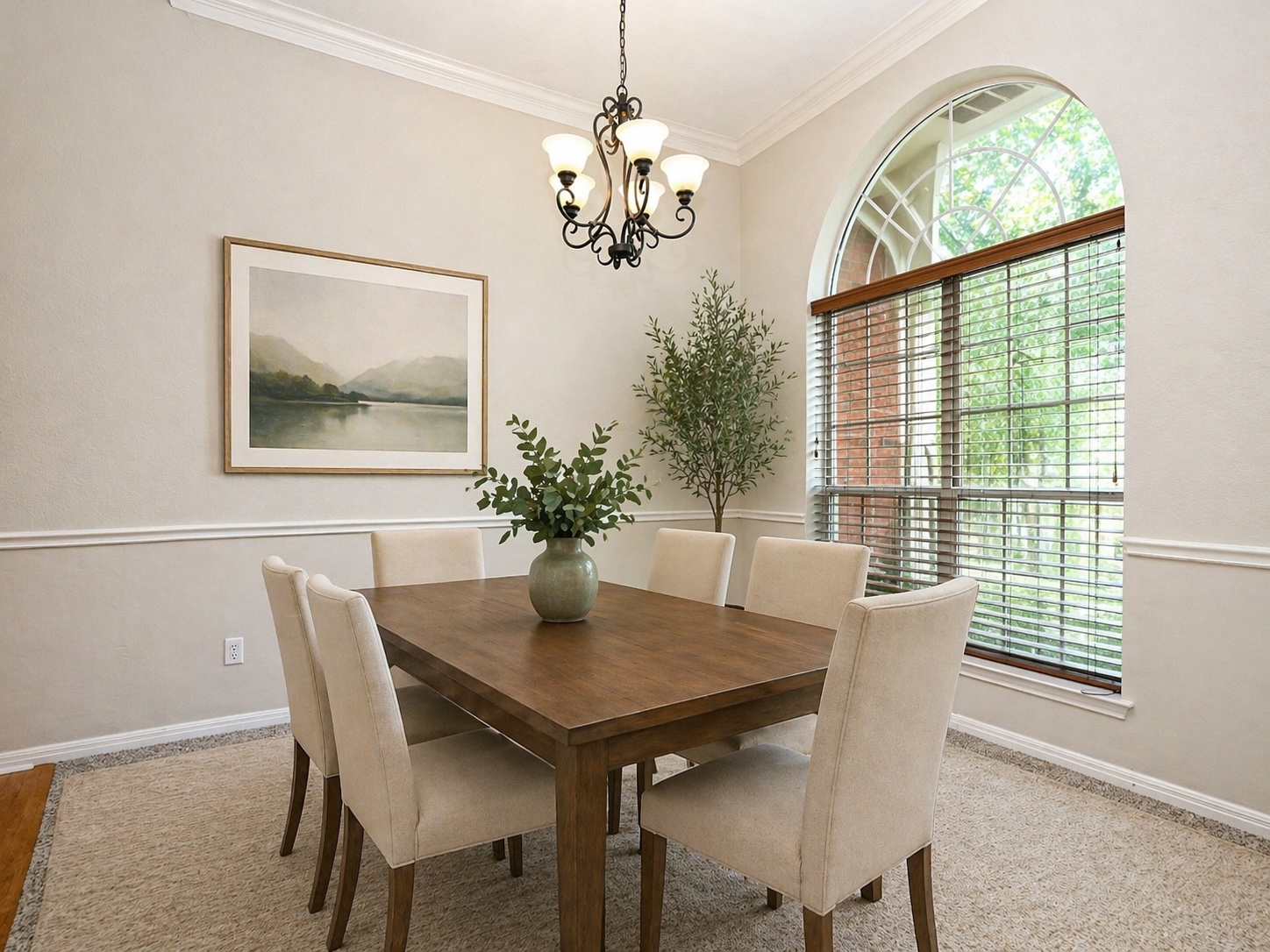 11017 Rio Vista Drive Austin, TX 78726 - Photo 9 of 38 Virtually-staged: Dining area featuring an arched window with blinds, crown molding, chair rail molding, and a chandelier