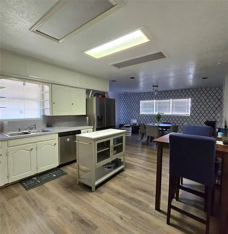 a kitchen with stainless steel appliances granite countertop a stove and a refrigerator