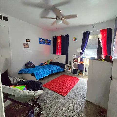 a living room with furniture gym equipment and a rug
