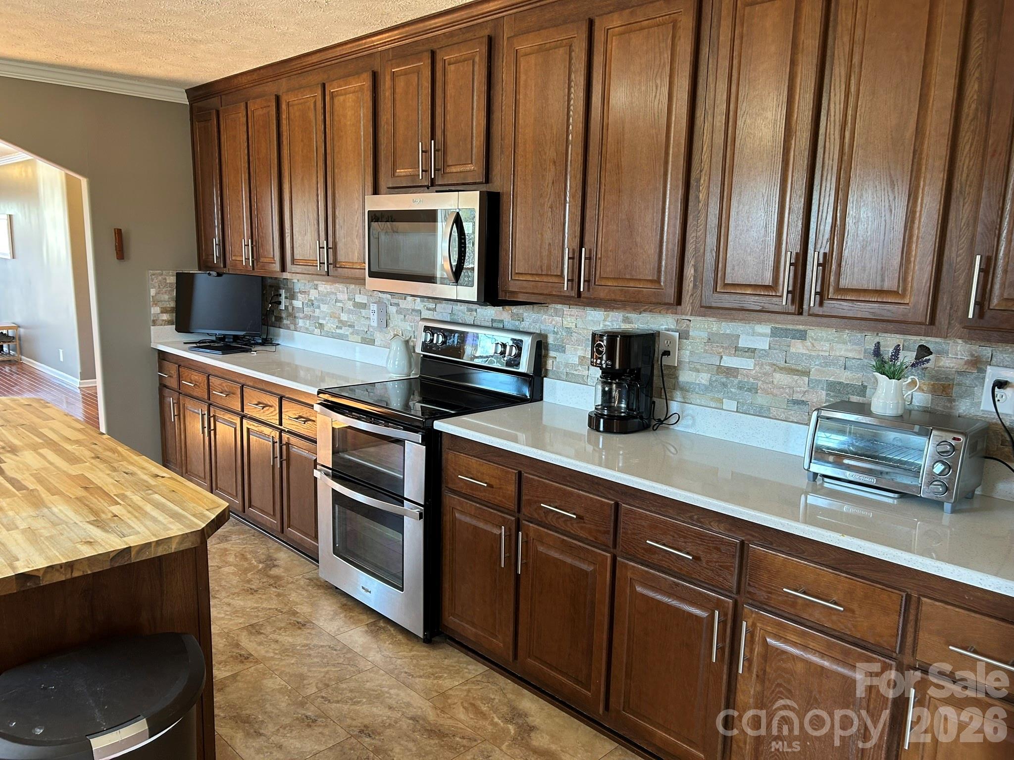 3343 Hollis Road Ellenboro, NC 28040 - Photo 24 of 48 a kitchen with stainless steel appliances granite countertop wooden cabinets a stove top oven a sink and dishwasher