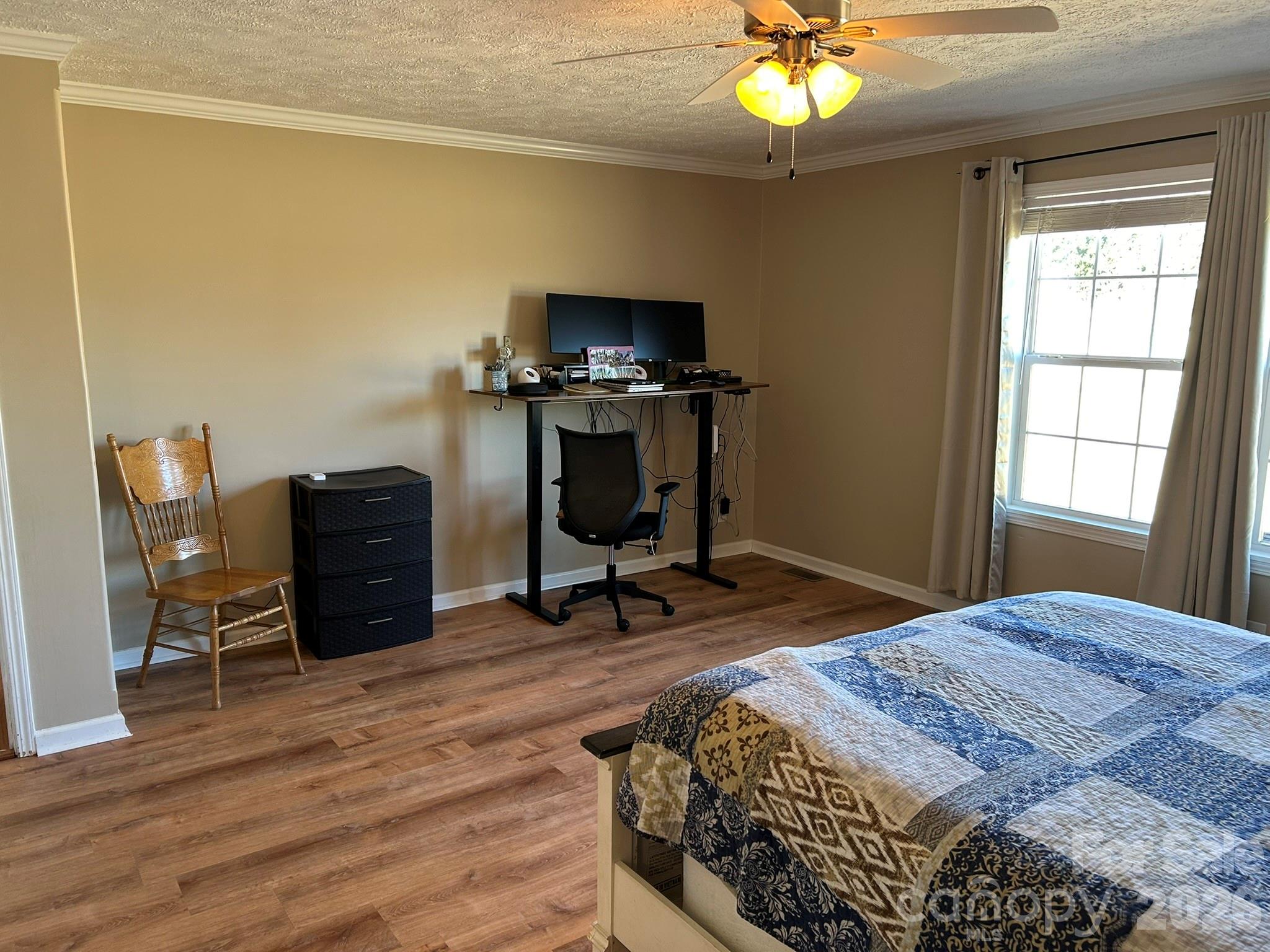 3343 Hollis Road Ellenboro, NC 28040 - Photo 27 of 48 a bedroom with a bed and a chandelier