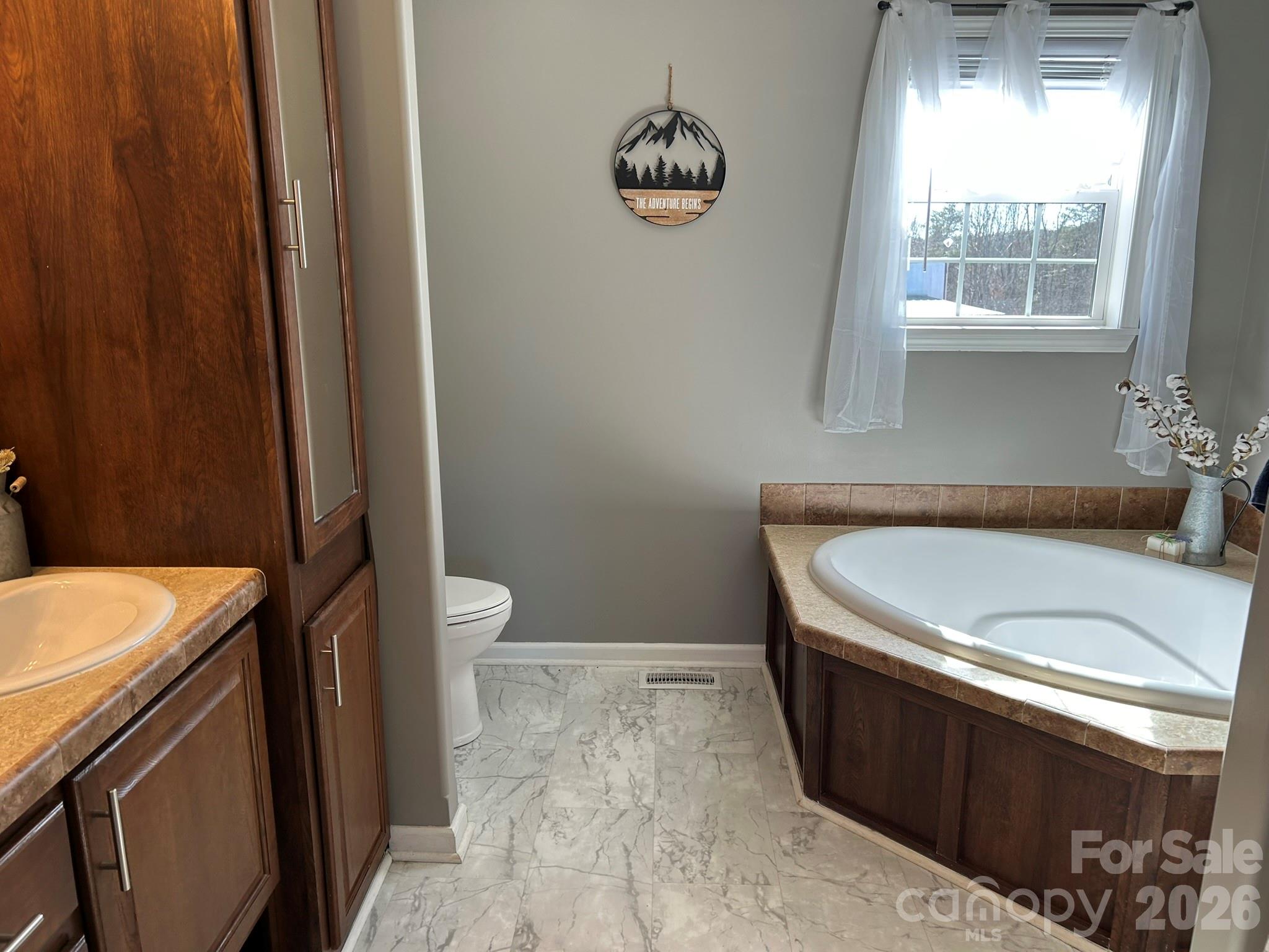 3343 Hollis Road Ellenboro, NC 28040 - Photo 29 of 48 a bathroom with a sink a toilet and tub