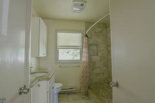 a bathroom with a shower and a toilet