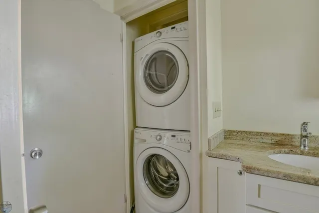 a utility room with sink dryer and washer