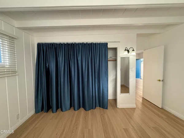 a view of a room with wooden floor