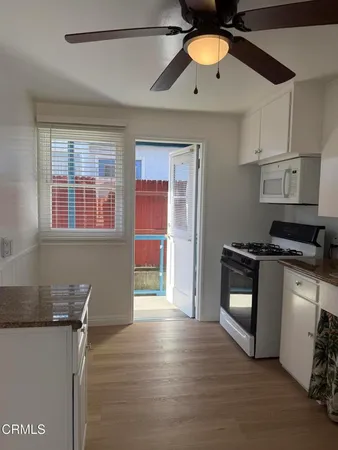 a kitchen with stainless steel appliances granite countertop a stove and a refrigerator