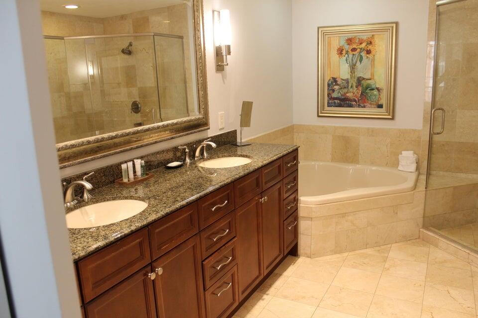 10 Harbor Boulevard, Unit 203B Destin, FL 32541 - Photo 11 of 18 a bathroom with a bathtub double vanity sink and a mirror