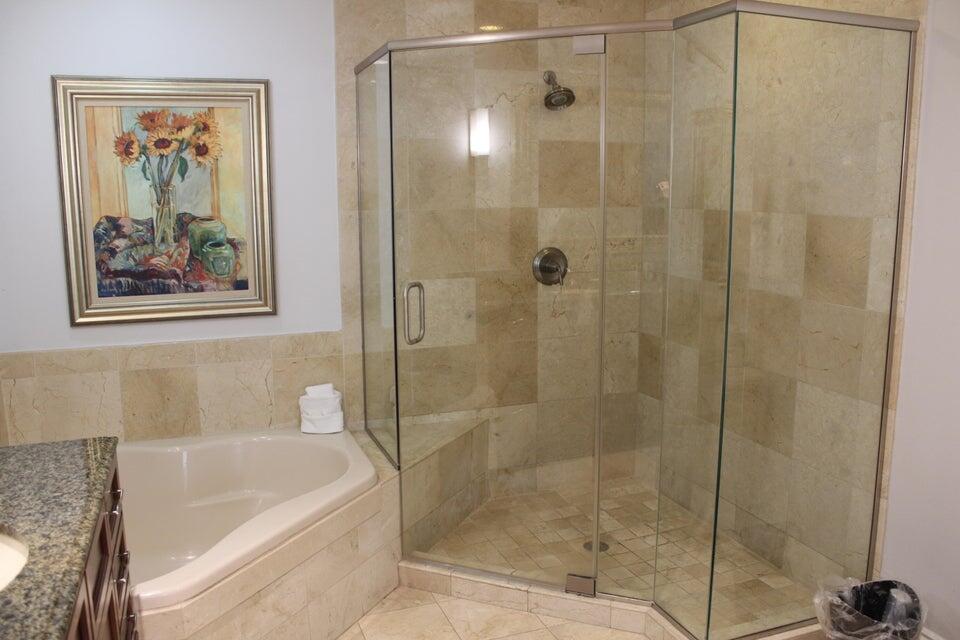 10 Harbor Boulevard, Unit 203B Destin, FL 32541 - Photo 12 of 18 a bathroom with a shower and a bath tub