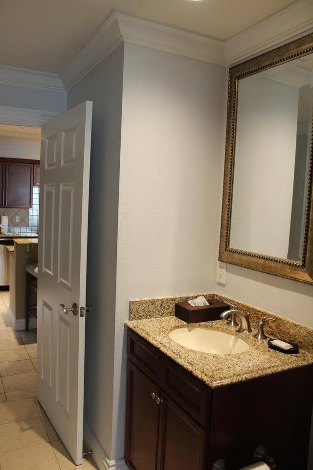 10 Harbor Boulevard, Unit 203B Destin, FL 32541 - Photo 14 of 18 a bathroom with a granite countertop sink and a mirror