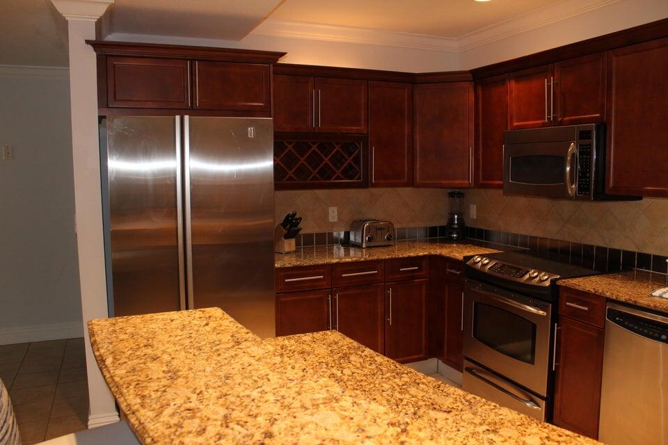 10 Harbor Boulevard, Unit 203B Destin, FL 32541 - Photo 15 of 18 a kitchen with a sink stove and microwave