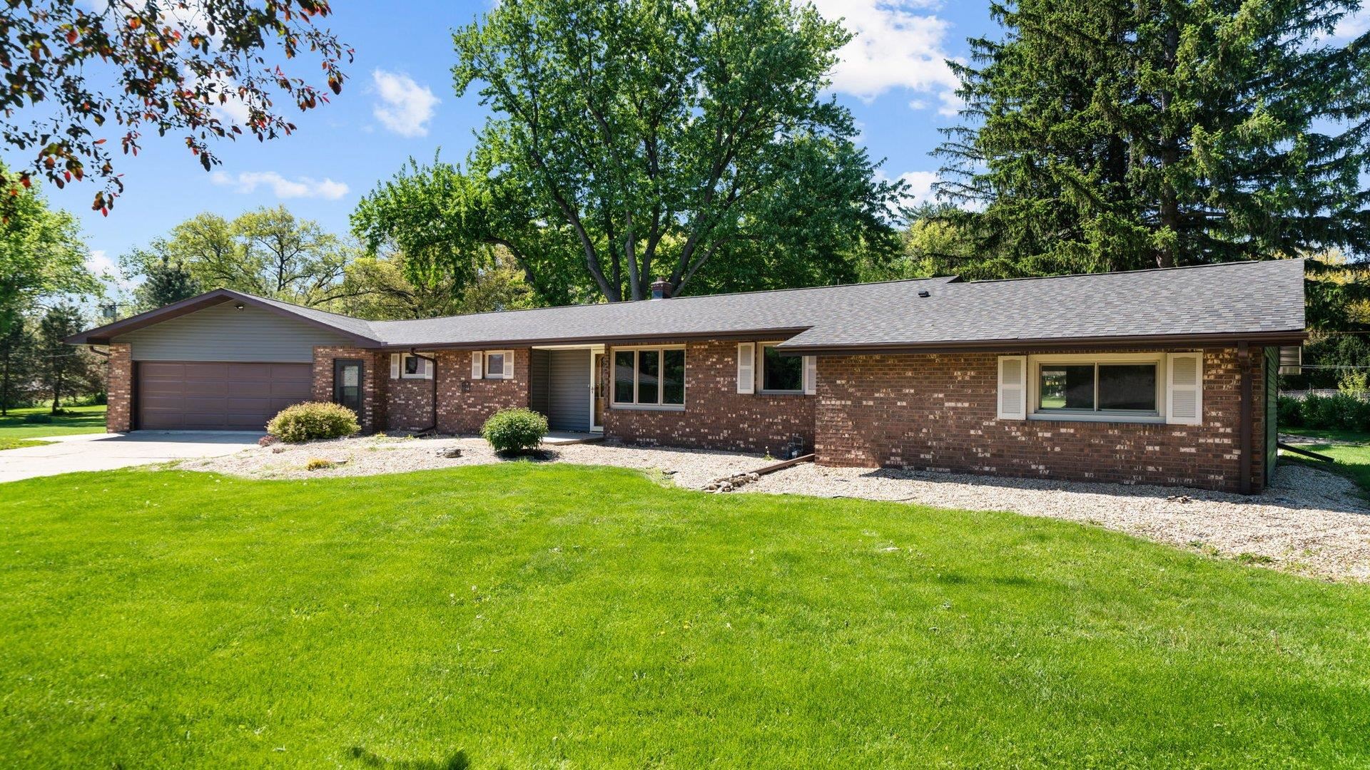 313 West Margaret Fuller Road Oregon, IL 61061 - Photo 1 of 46 a front view of house with a garden