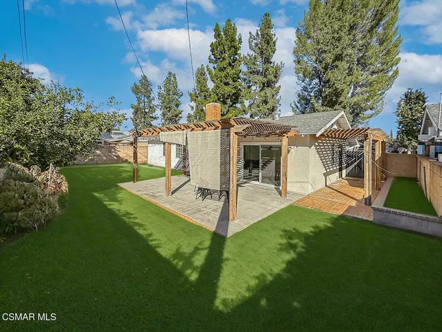 a view of a house with a yard porch and sitting area