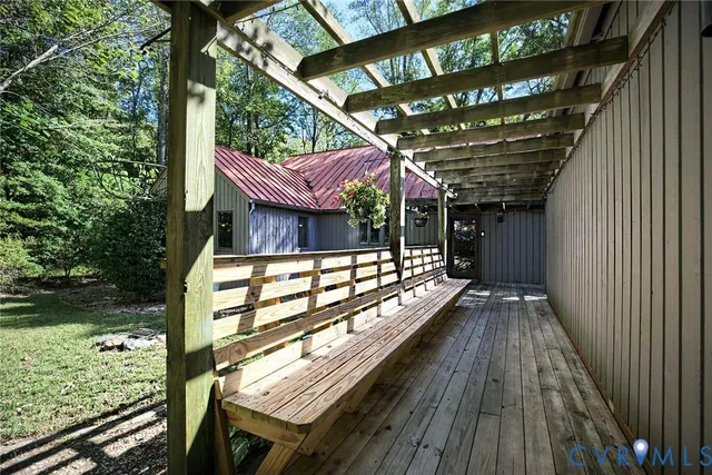 a view of backyard with deck and outdoor seating