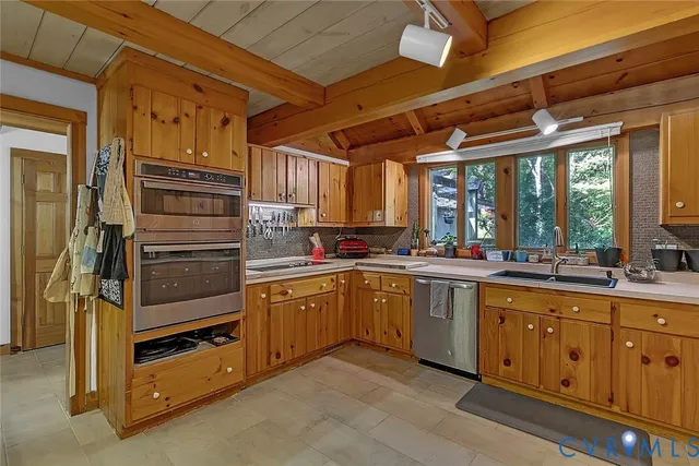 a kitchen with a sink a counter cabinets and a window