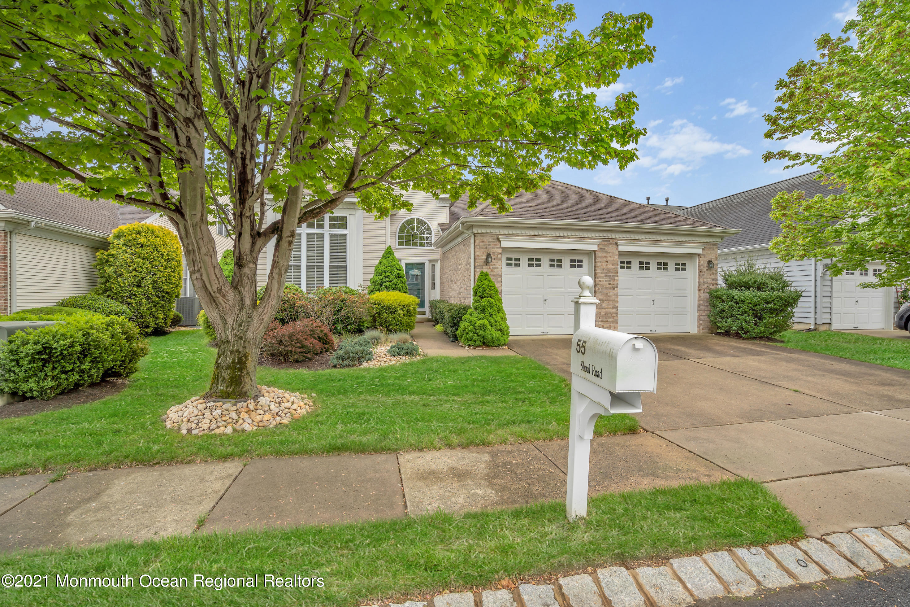 55 Shoal Road Jackson, NJ 08527 - Photo 3 of 55 a front view of a house with a garden and trees