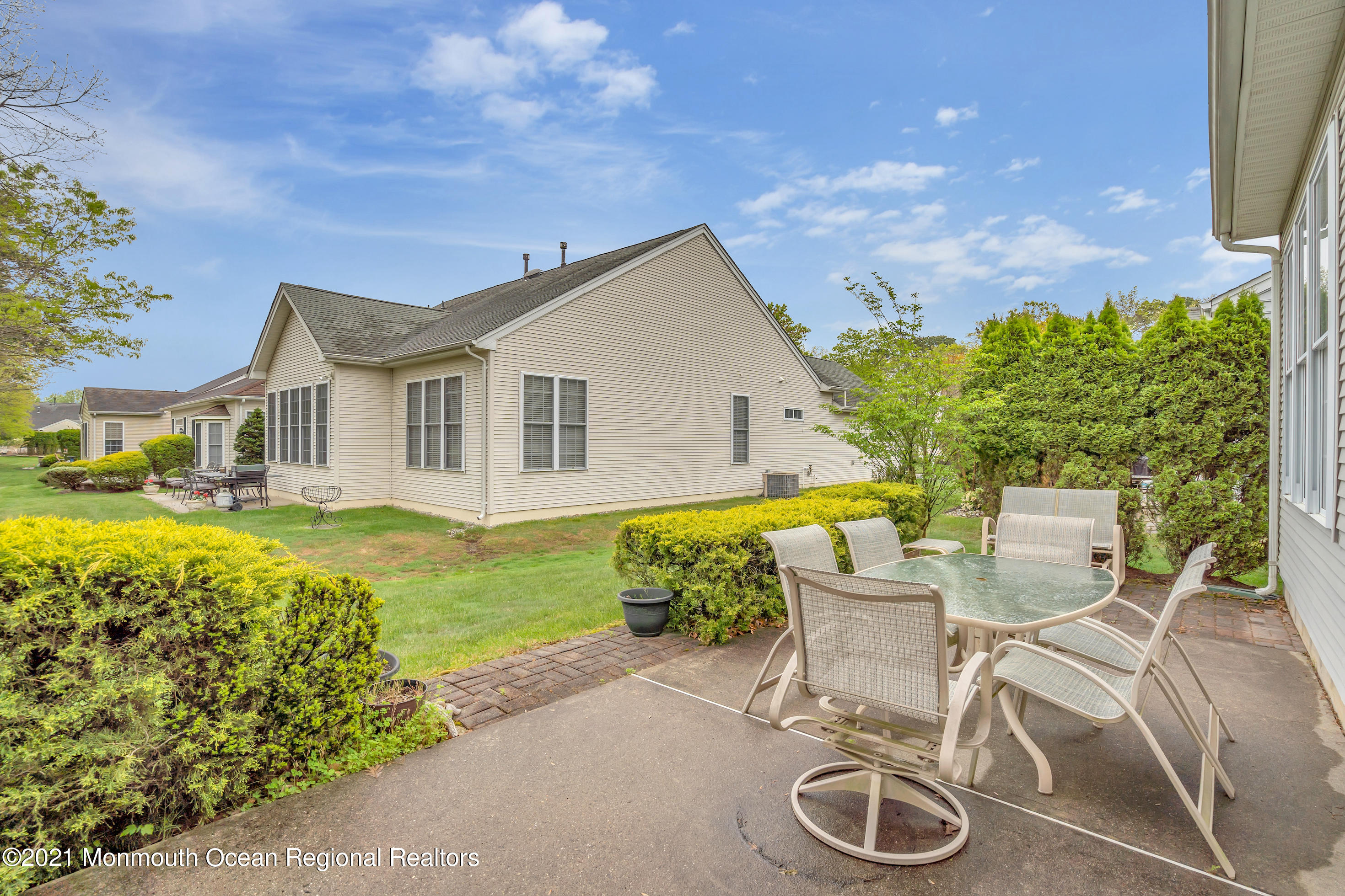 55 Shoal Road Jackson, NJ 08527 - Photo 29 of 55 a view of a patio with table and chairs and potted plants