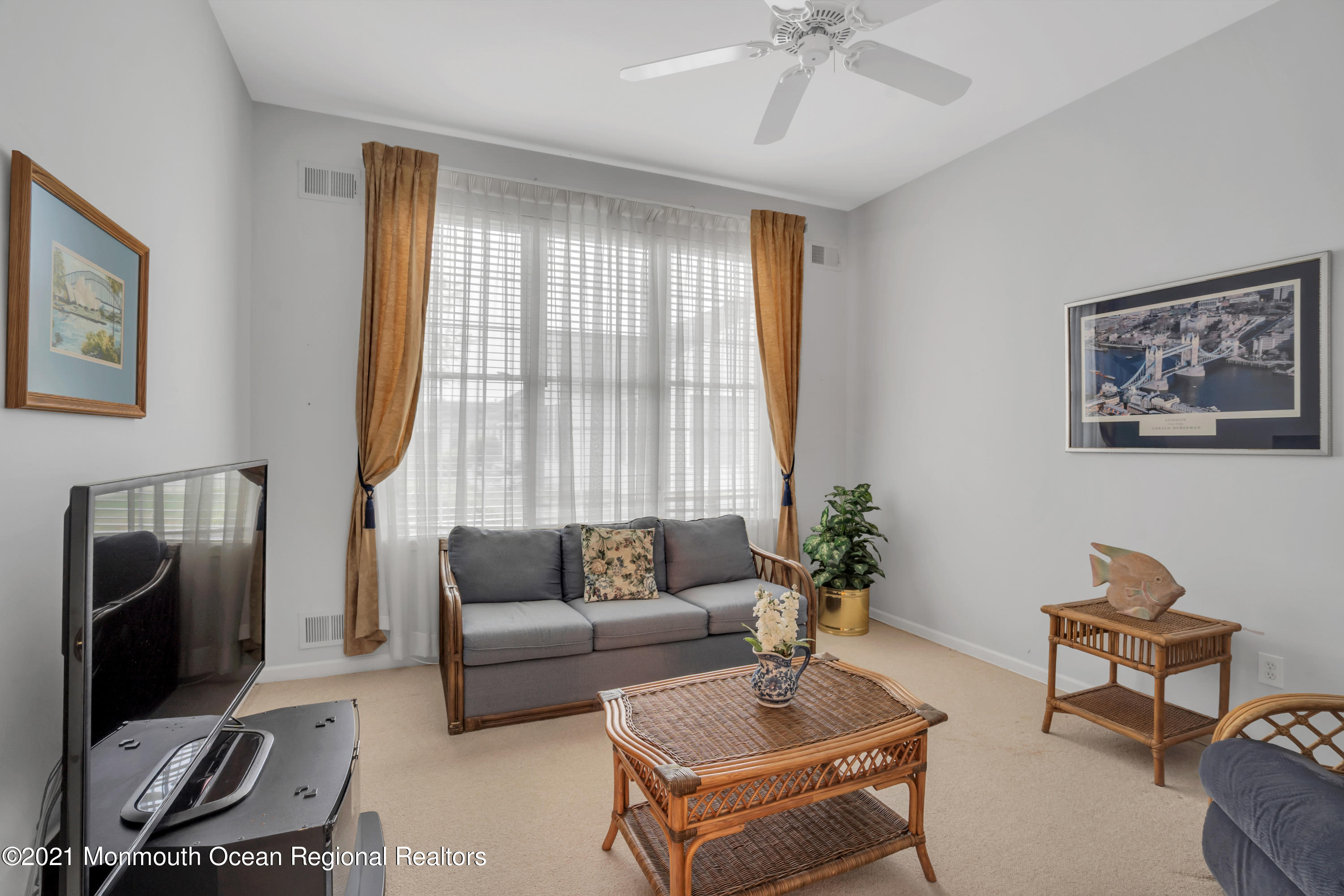 55 Shoal Road Jackson, NJ 08527 - Photo 32 of 55 a living room with furniture a flat screen tv and a window