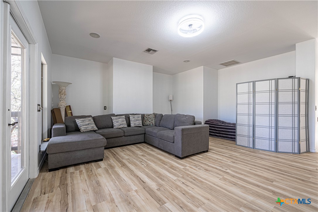 519 Long Meadow Spring Branch, TX 78070 - Photo 19 of 33 a living room with furniture and a wooden floor