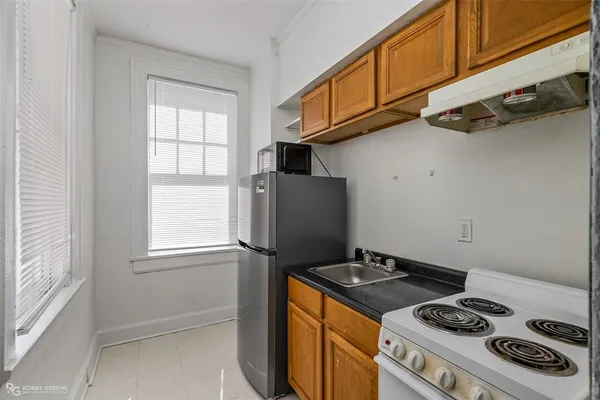 a kitchen with granite countertop a stove and a refrigerator