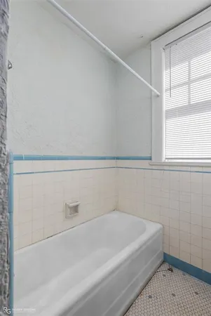 a bathroom with a white bath tub and a shower