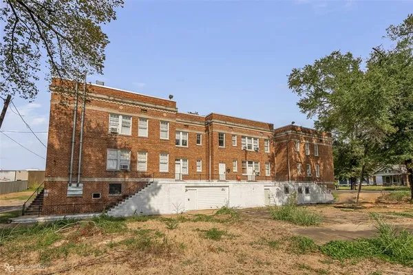 a view of a building with a yard