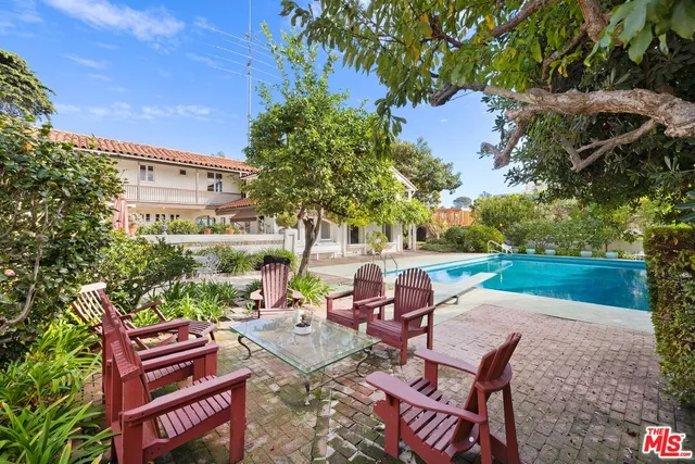 a view of a patio with table and chairs and potted plants