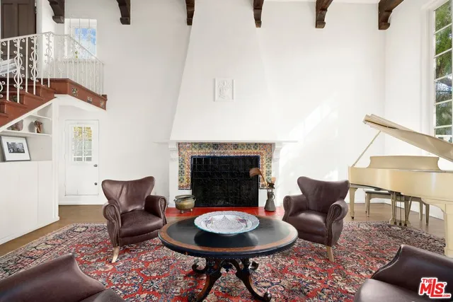 a living room with furniture a rug and a fireplace