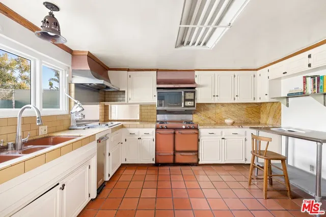 a kitchen with stainless steel appliances granite countertop a sink and cabinets