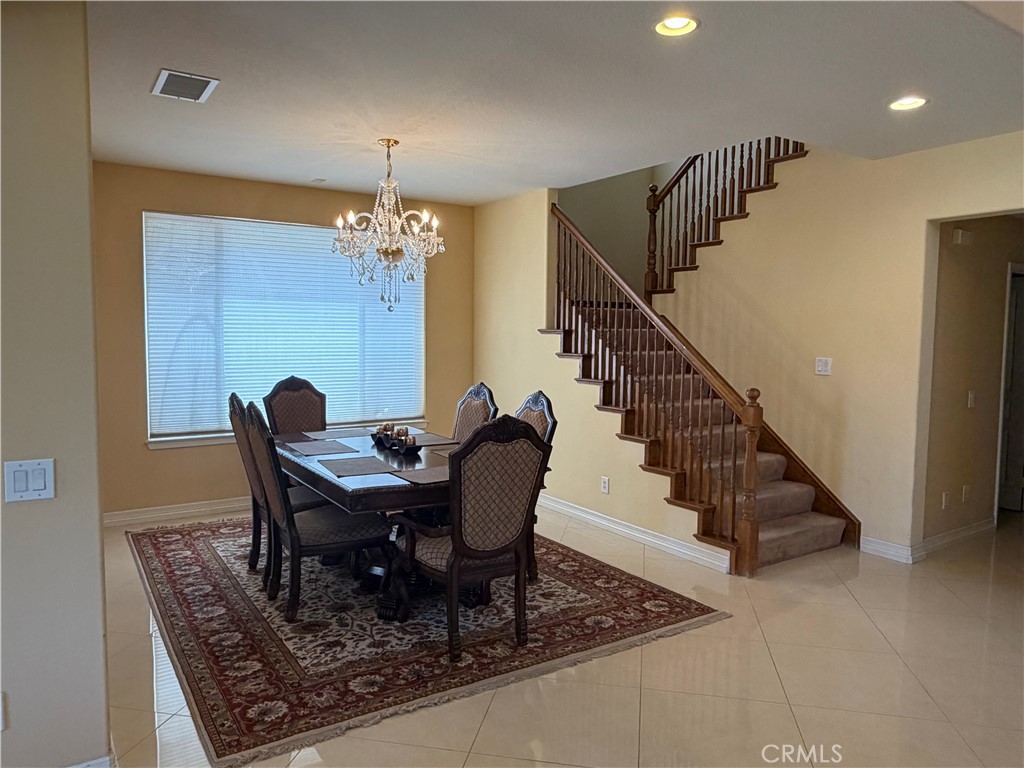 19823 Mariposa Pines Way Porter Ranch, CA 91326 - Photo 17 of 50 a dining room with furniture a chandelier and wooden floor