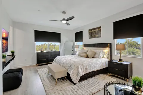 a bedroom with a bed and a flat screen tv