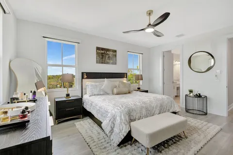 a bedroom with a bed and a chandelier