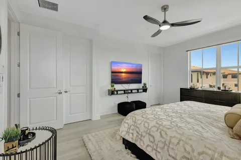 a bedroom with a bed and a flat screen tv