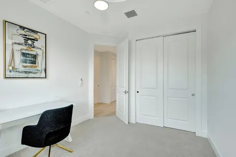 a bedroom with a chair and a chair