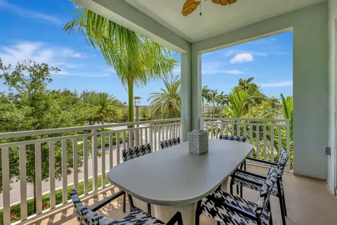 a view of a chairs and table in the balcony